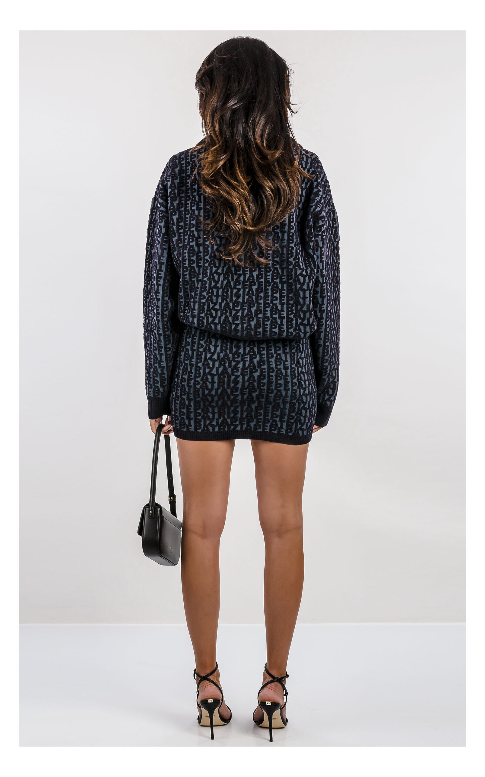 sweter patrizia pepe grafitowy w czarny szenilowy monogram, ciepły o luźnym fasonie z dzianinową spódniczką mini- widok na modelce od tyłu